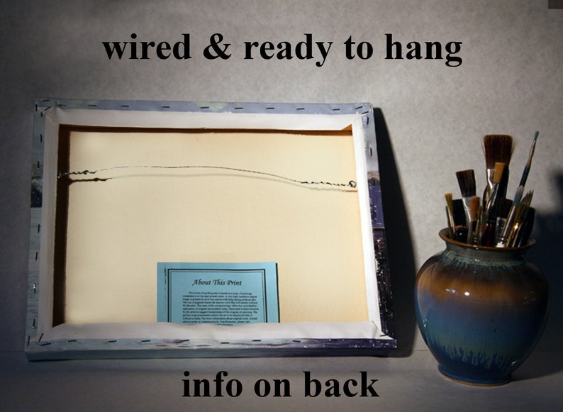 May include: The back of a canvas print with a wire hanging system. The print has a blue and white border and a white background. A small blue card with the text "About This Print" is attached to the back of the canvas.
