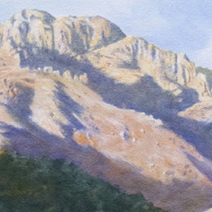 May include: Watercolour painting of a mountain range. The mountain is a light tan colour with shadows of purple and blue. The sky is a light blue. The bottom of the painting has green trees and a hint of a valley.