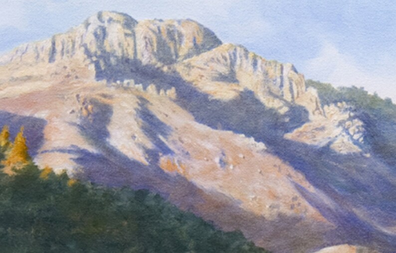 May include: Watercolour painting of a mountain range. The mountain is a light tan colour with shadows of purple and blue. The sky is a light blue. The bottom of the painting has green trees and a hint of a valley.