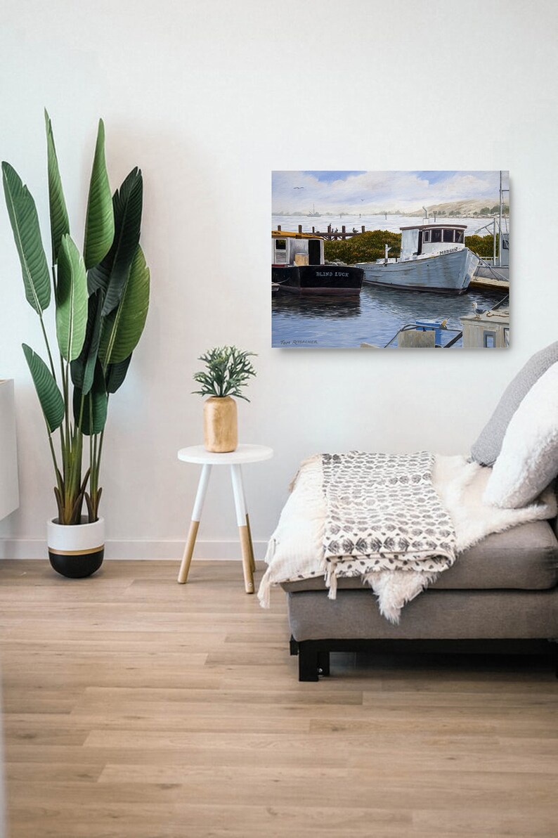May include: A painting of two boats docked at a pier. The boat on the left is black and says "Blind Luck" on the side. The boat on the right is white and has a blue roof. The painting is set against a blue sky with white clouds.