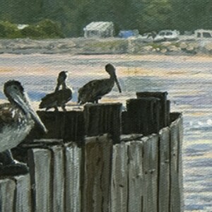 May include: An oil painting depicts three pelicans perched on weathered wooden pilings. The birds have brown and white plumage and long beaks. The background shows a beach scene with water, a shoreline, and a few buildings.