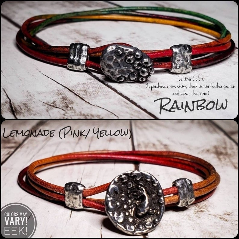 May include: Two leather bracelets with silver button closures. The top bracelet is rainbow colored and the bottom bracelet is red, orange, and yellow. The text "RAINBOW" and "LEMONADE (PINK/YELLOW)" is visible in the image. The text "COLORS MAY VARY! EEK!" is also visible in the image.
