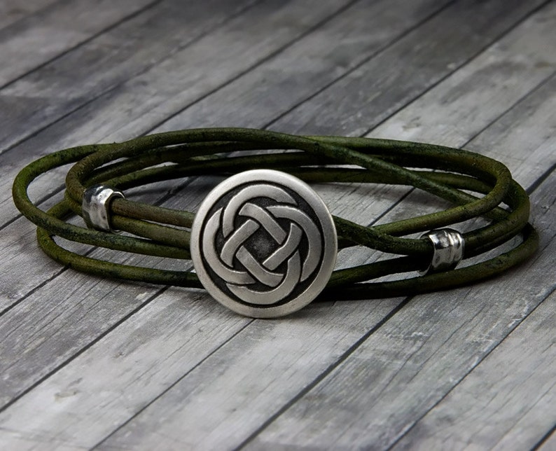 May include: A green leather wrap bracelet with a silver Celtic knot charm.