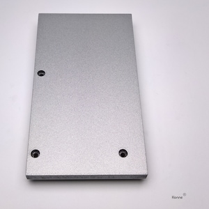 May include: A silver metal plate with three holes drilled into it. The plate has a textured surface.