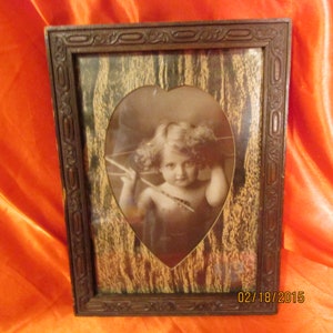 Bébé Cupidon de 1897 avec flèche et arc.