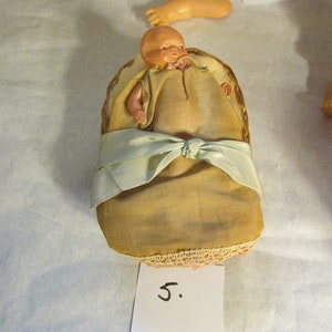 Antique Celluloid Baby Doll In Basket with wool bedding