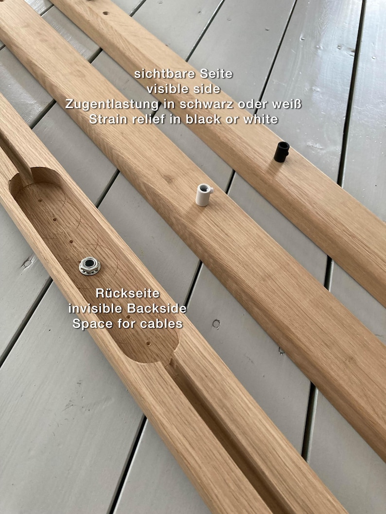 May include: Two wooden pieces for a furniture project. The top piece has the text "sichtbare Seite visible side Zugentlastung in schwarz oder wei&szlig; Strain relief in black or white". The bottom piece has the text "R&uuml;ckseite invisible Backside Space for cables".