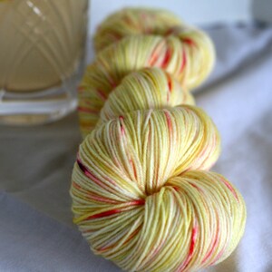 Hand dyed DK superwash merino yarn, lemonade hand dyed yarn, yellow speckled yarn with red and pink speckles