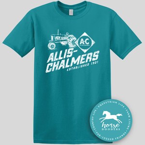 May include: Teal t-shirt featuring a white graphic of a tractor and the text "ALLIS-CHALMERS ESTABLISHED 1901". A circular logo with a horse graphic and the text "horse doodles" is on the bottom right.
