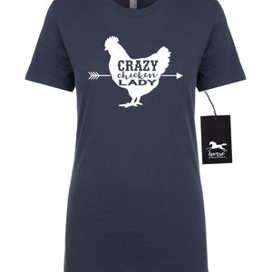 May include: Navy blue t-shirt with a white graphic of a chicken and the text "Crazy Chicken Lady". The shirt has short sleeves and a crew neck. A black tag with a horse logo is attached.