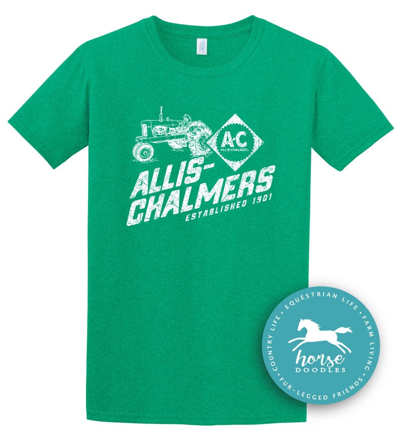 May include: A green t-shirt featuring a white graphic of a tractor and the text "ALLIS-CHALMERS ESTABLISHED 1901". The shirt also has the letters "AC" inside a diamond shape. A circular logo with a horse is in the bottom right corner.