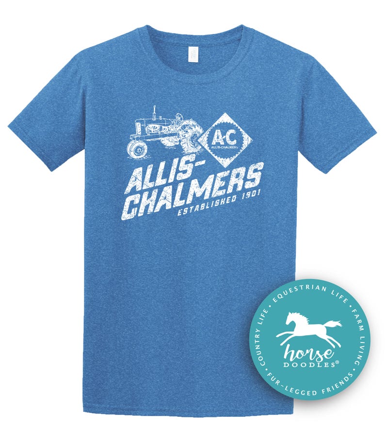 May include: Blue short-sleeved t-shirt with a distressed white graphic featuring a tractor, the text "ALLIS-CHALMERS ESTABLISHED 1901", and the "AC" logo. A round sticker with a horse graphic is on the bottom right.
