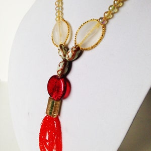 A stately necklace in gold, red and orange tones