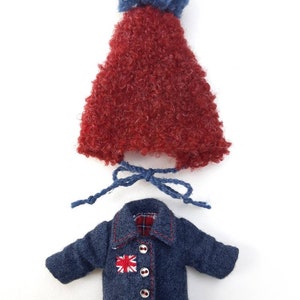May include: A red fuzzy hat with a blue pom pom and a blue denim jacket with a red and white Union Jack patch and red stitching.