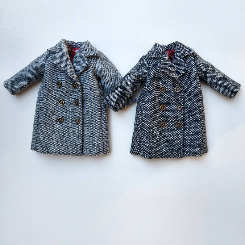 May include: Two gray tweed double-breasted coats with gold buttons.