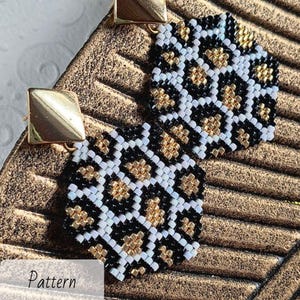 May include: A pair of handmade beaded earrings with a leopard print design. The earrings feature a pattern of black, white, and gold beads. The earrings are square-shaped and have gold-colored square studs. The word "Pattern" is visible in the image.