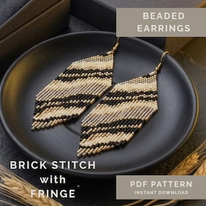 May include: Beaded earrings featuring a diamond-shaped brick stitch pattern in black, cream, and metallic gold. The earrings include a fringe bottom and gold-tone ear wires. Text on the image reads: BEADED EARRINGS, BRICK STITCH with FRINGE, PDF PATTERN.