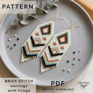 May include: A pair of long, diamond-shaped beaded earrings featuring a geometric pattern in white, black, turquoise, and tan. The earrings have gold-tone metal hooks and a fringe bottom. The text reads PATTERN, BRICK STITCH earrings with fringe, PDF INSTANT DOWNLOAD, and OksiAnna.