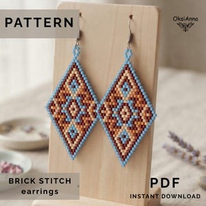 May include: Diamond-shaped beaded earrings featuring a geometric pattern in shades of light blue, tan, and dark brown. The earrings are suspended from metal hooks and display the text PATTERN, BRICK STITCH earrings, PDF, and OksiAnna.