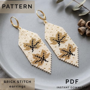 May include: A pair of beaded earrings featuring a white background with gold and black maple leaf patterns. The earrings are crafted with a brick stitch technique and include gold-toned lever back ear wires. The text reads PATTERN PDF.