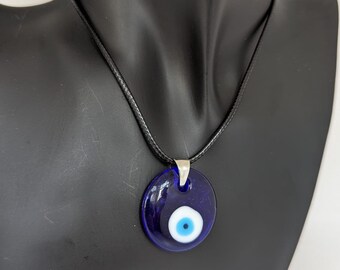 Evil Eye Glass Necklace with adjustable cord comes with a velvet pouch. comes in Blue, Red and White.