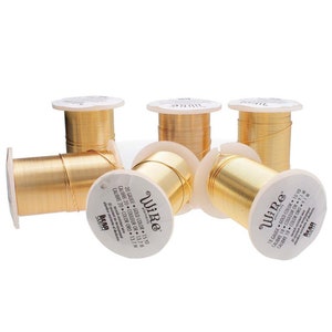May include: Six spools of gold-colored wire, each labeled "Wire" with the gauge and length in inches. The spools are arranged in a semi-circle on a white background.