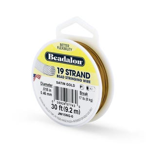 May include: A spool of Beadalon 19 Strand bead stringing wire in Satin Gold. The label indicates a diameter of .018 in (0.46 mm), a break strength of 17 lb (8 kg), and a length of 30 ft (9.2 m). The packaging includes the text "Better Flexibility".