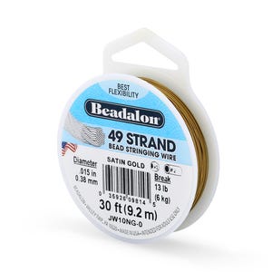 May include: A spool of Beadalon 49 Strand bead stringing wire in satin gold. The label indicates a diameter of 0.38 mm and a break strength of 6 kg. The spool contains 9.2 m of wire.