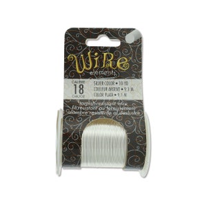 May include: Silver-colored, tarnish-resistant wire on a spool. The packaging reads "Wire elements" and includes details about the gauge and length, which is 10 yards. The label also states "tarnish-resistant wire".