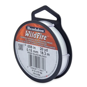 May include: A spool of white Beadalon WildFire thermally bonded bead weaving thread. The spool is labeled with the thread size, 0.006 inches or 0.15 mm, and the length, 20 yards or 18.3 meters. The label also includes the text "Frost/Blanc/Blanco".