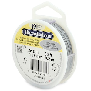 May include: A spool of 0.015 inch (0.38 mm) satin silver beading wire. The spool is 30 feet (9.2 meters) long and is labeled "Beadalon" with the product number "JW14NS-0".