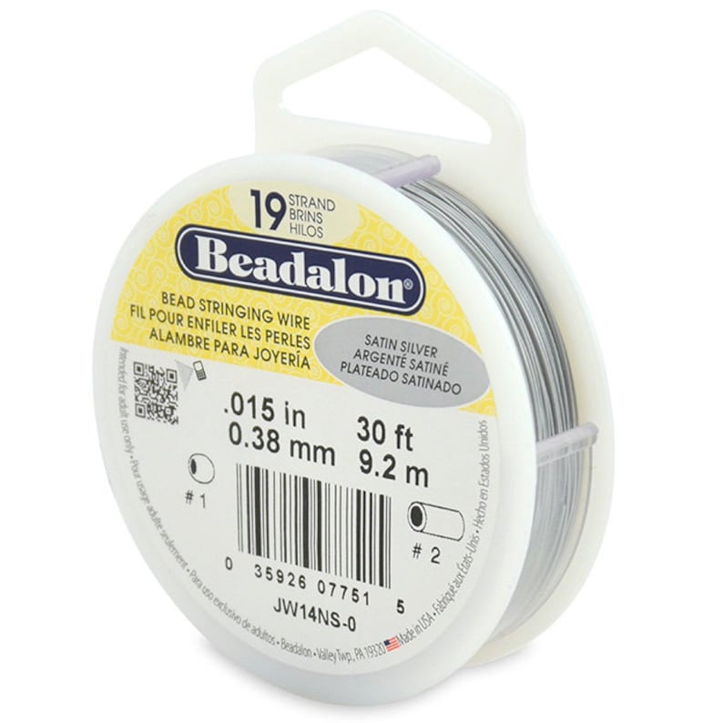 May include: A spool of 0.015 inch (0.38 mm) satin silver beading wire. The spool is 30 feet (9.2 meters) long and is labeled "Beadalon" with the product number "JW14NS-0".