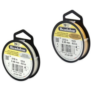 May include: Two spools of Beadalon bead stringing wire. The spool on the left is silver plated and is 15 feet long, 0.018 inches in diameter, and 0.46 mm in diameter. The spool on the right is 24k gold plated and is 15 feet long, 0.015 inches in diameter, and 0.38 mm in diameter.