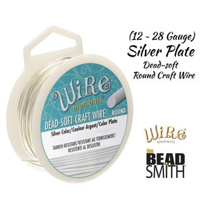 May include: A spool of silver-plated, dead-soft round craft wire. The wire is tarnish-resistant and comes in gauges 12-28. The label reads "Wire elements DEAD-SOFT CRAFT WIRE ROUND Silver Color/Couleur Argent/Color Plata Tarnish-Resistant/Resistant au ternissement/Resistente al deslustre" and "the BEAD SMITH".
