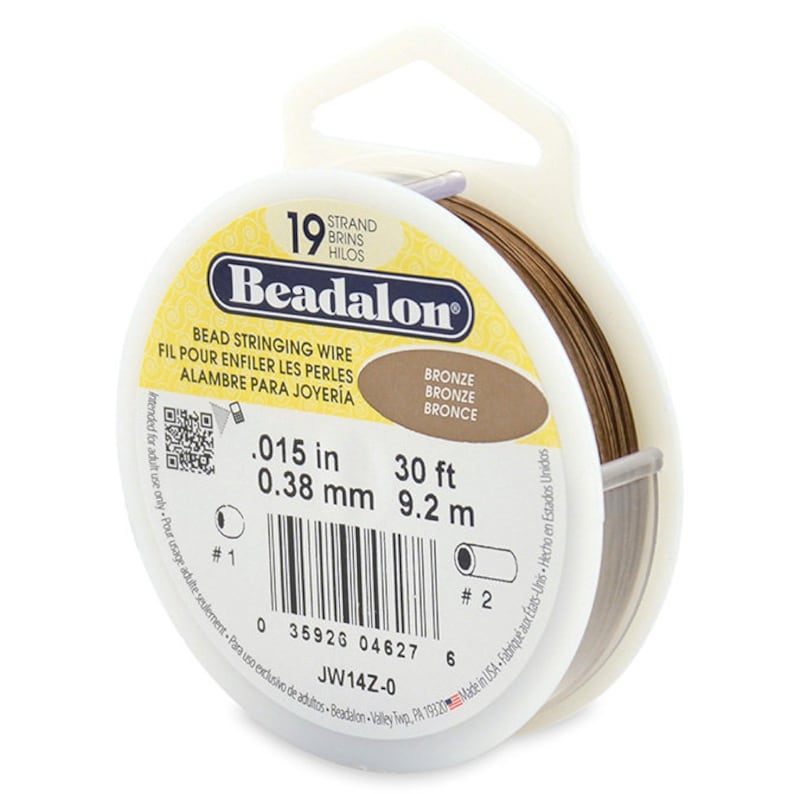 May include: A spool of 19 strand bronze bead stringing wire. The wire is 0.015 inches thick and 30 feet long. The spool is labeled "Beadalon" and has a barcode.