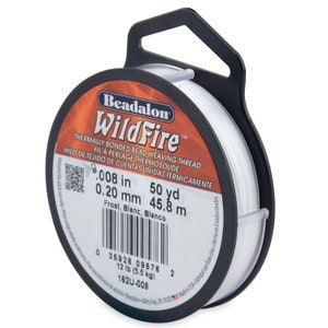 May include: A spool of white Beadalon WildFire thermally bonded bead weaving thread. The label indicates it is 0.008 inches (0.20 mm) thick and 50 yards (45.8 meters) long. It weighs 12 pounds (5.5 kg).