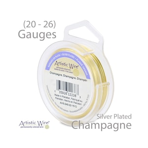 May include: A spool of silver-plated champagne colored wire. The spool is labeled "Artistic Wire" and "Champagne, Champagne, Champ&aacute;n". The wire is 22 gauge and 15 yards long.