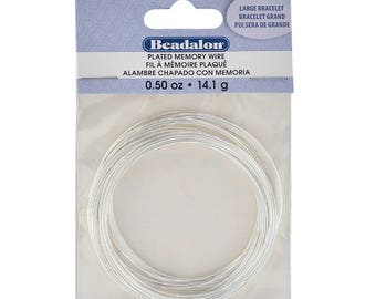 May include: A package of silver plated memory wire, labeled "Beadalon Plated Memory Wire 0.50 oz 14.1 g". The wire is coiled in a circle and is ready to be used for jewelry making.