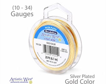 May include: A spool of silver-plated gold-colored Artistic Wire, 20 ft (6.1 m), 18 gauge, .040 in (1.00 mm). The packaging includes the text "Artistic Wire Craft Wire Gold Color". The wire is wound on a clear plastic spool.