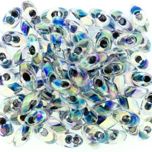 May include: A pile of iridescent oval-shaped beads with a central hole. The beads have a clear, reflective surface with hints of blue, green, and yellow, creating a shimmering effect. These beads are ideal for jewelry making and crafts.