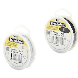 May include: Two spools of Beadalon bead stringing wire. One spool is white and the other is black. Both spools are 30 feet long and have a 19 strand count. The white spool is 0.018 inches or 0.46 millimeters in diameter. The black spool is 0.015 inches or 0.38 millimeters in diameter.