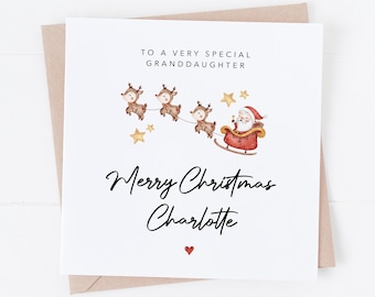 May include: A square Christmas card with a watercolor illustration of Santa Claus in a sleigh pulled by reindeer. The card reads "To a very special granddaughter" and "Merry Christmas Charlotte."