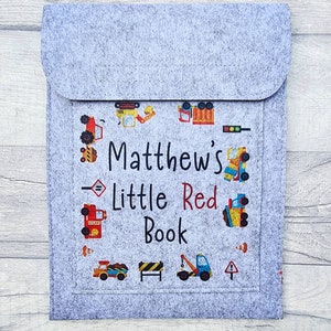 May include: Gray felt book cover with a colorful design of construction vehicles and the text "Matthew's Little Red Book".