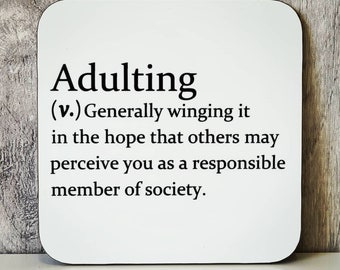 Puede incluir: Posavasos blanco con texto negro que dice "Adulting (v.) Generally winging it in the hope that others may perceive you as a responsible member of society."