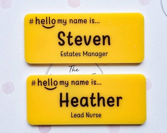 May include: Two yellow name tags with black text. The top tag reads "#hello my name is... Steven Estates Manager". The bottom tag reads "#hello my name is... Heather Lead Nurse".