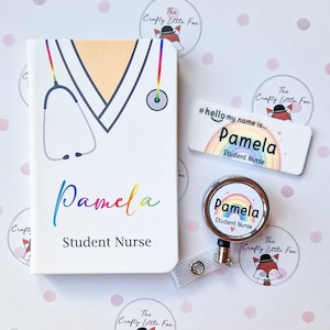 May include: A white notebook with a rainbow stethoscope and the text "Pamela Student Nurse". A rainbow name tag with the text "#hello my name is... Pamela Student Nurse" and a rainbow retractable badge holder with the text "Pamela Student Nurse" are also included.