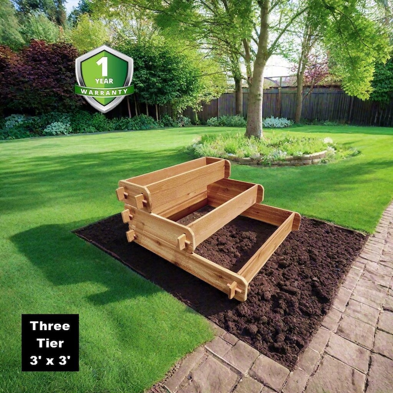 May include: Three-tier wooden raised garden bed with a 3' x 3' footprint. The bed is made of natural wood and is shown in a backyard setting. The image includes a 1-year warranty label.