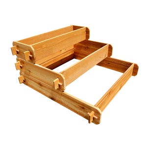 May include: A three-tiered wooden planter box, made of natural wood, with a light brown finish. The planter box is designed to be stacked, with each tier slightly smaller than the one below it. The planter box is perfect for growing herbs, flowers, or vegetables.
