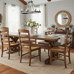 May include: A dining room set with a large wooden table and six chairs. The chairs have woven seats and ladder backs. A chandelier hangs above the table, and a rug covers the floor. The room is decorated with mirrors, plants, and candles.
