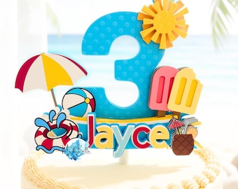 May include: A cake topper featuring a large blue number three with a textured surface, a yellow sun, a beach umbrella, a beach ball, a life ring, two popsicles, and a pineapple drink. The name Jayce is written in red and blue letters.